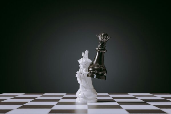 A chess piece symbolizes strategic decisions during economic contraction; cutting isn't always the best choice.